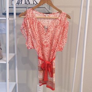 Yuka blouse in size 40. Pink and white flower design with tie at bottom.